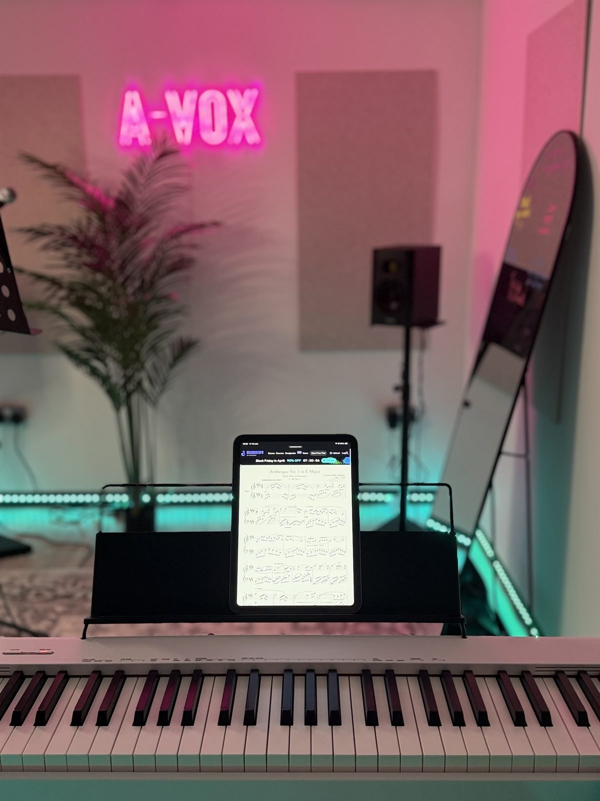 Piano teacher London — A-VOX studio with digital piano and Debussy Arabesque sheet music